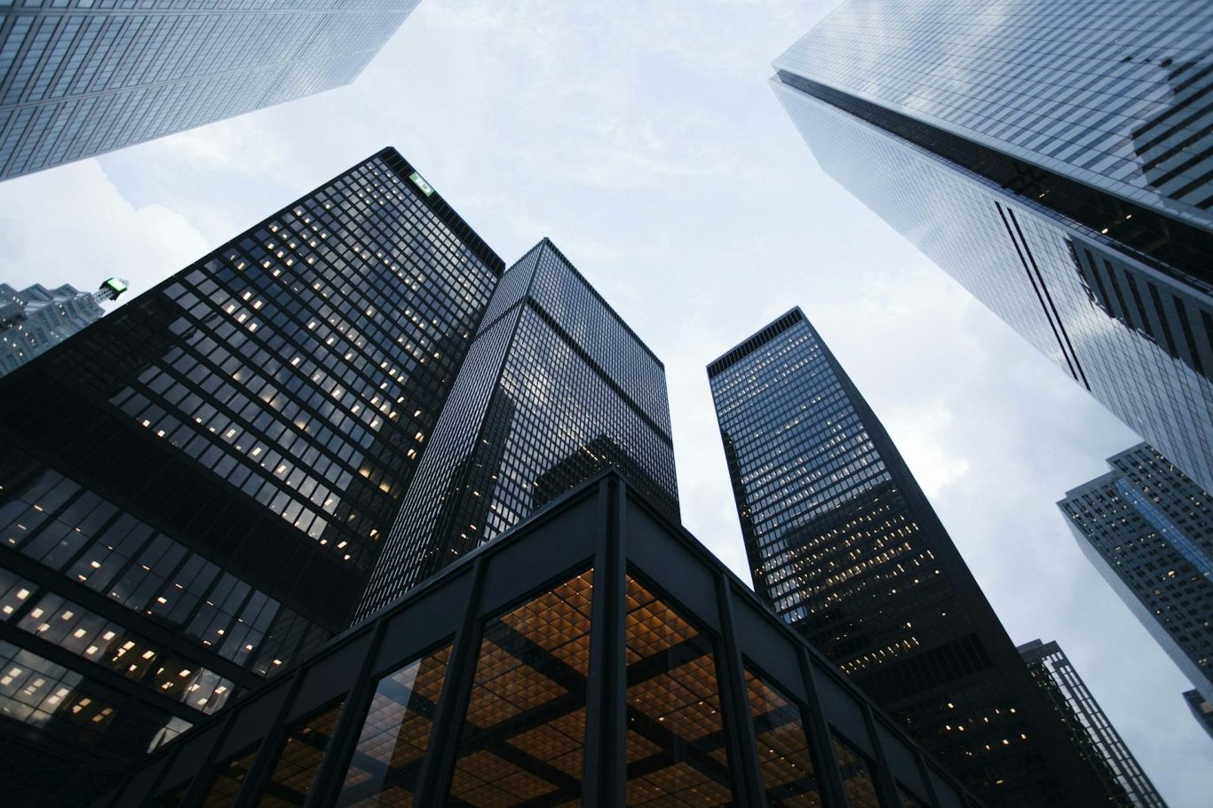 Retirement planning for business owners Skyscrapers in a financial district near San Francisco reach toward a cloudy sky, viewed from ground level.